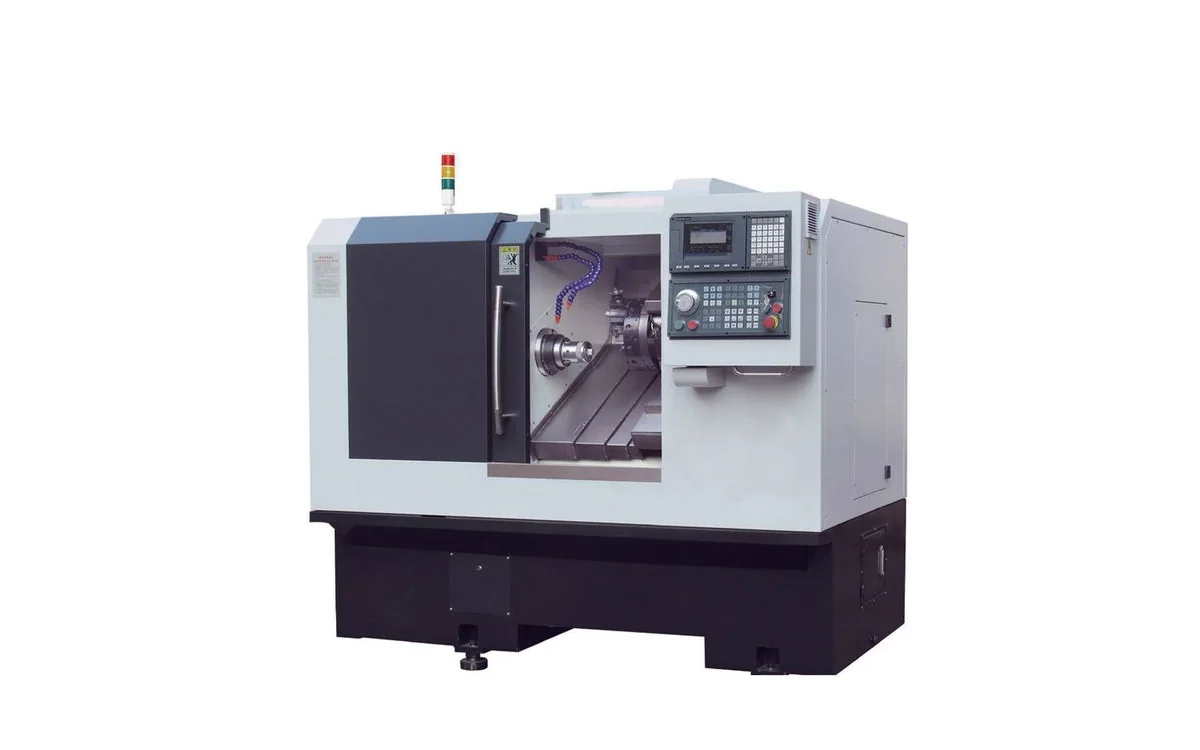 Taikan TCK52 big-bore slant-bed CNC turning center machining an alloy steel shaft between hydraulic chuck and MT5 tailstock